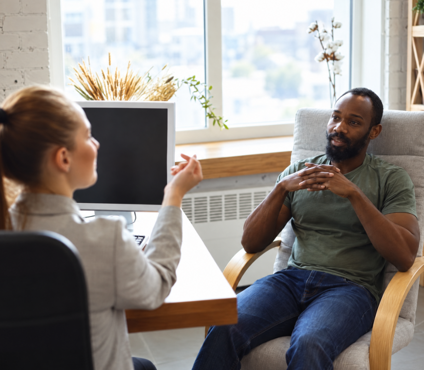 A patient in conversation with a clinician in a bright office